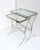 A set of chrome and glass nesting end or side tables, Mid‑Century Modern design, circa mid‑20th century. A set of...