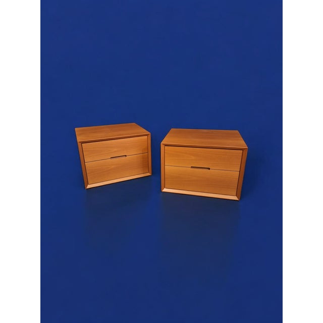 Pair of cherry wood bedside tables manufactured by Lema in the 1980s. Each bedside table has two large drawers with soft-...