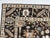 An allover Oushak-design carpet on a deep brown-black field, with the open drawing and large, spaced motifs the style is...