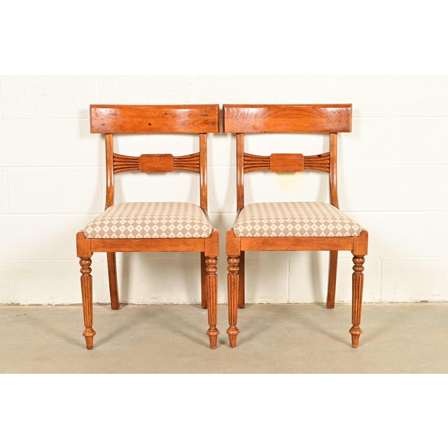 A gorgeous pair of Italian Provincial or English Regency style side chairs or dining chairs By Baker Furniture, "Milling...