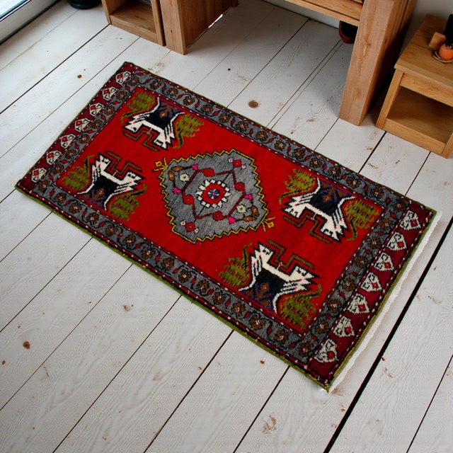 This vibrant hand-knotted Oushak mat brings a punch of saturated color and tribal energy to any small space. Its bold red...