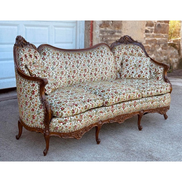 An Early 20th Century Victorian Serpentine Sofa Professionally Reupholstered in a Period Conscious Cream Floral Textile...