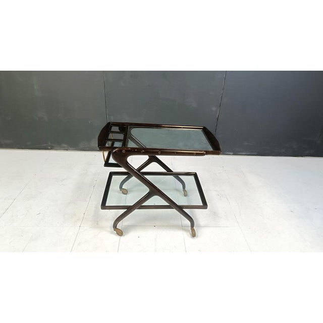 Fifties two tier serving trolley or bar cart in the style of Cesare Lacca. Fantastically crafted and elegant italian...