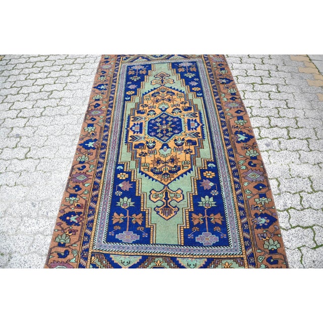 This is a vintage Turkish Oushak rug from the 1960s. The piece was hand-knotted.