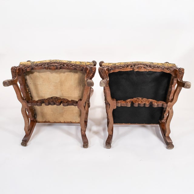 Pair of circa 1870 French Régence / Louis XIV–XV Revival hand‑carved solid walnut armchairs. Monumental in scale and...