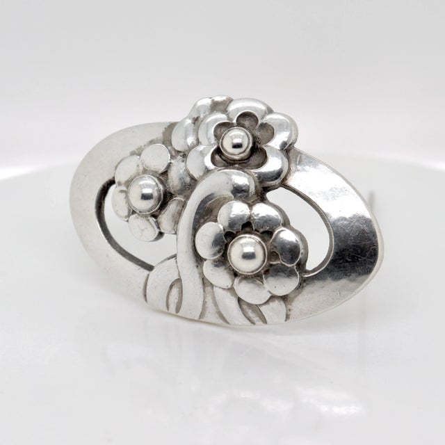 A fine Georg Jensen sterling silver pin or brooch. Model no. 28. Designed by Georg Jensen. In the form of a hand-hammered,...