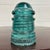 This is a gorgeous antique teal glass Hemingray No 12 insulator embossed “HEMINGRAY 12.”Produced by the Hemingray Glass...