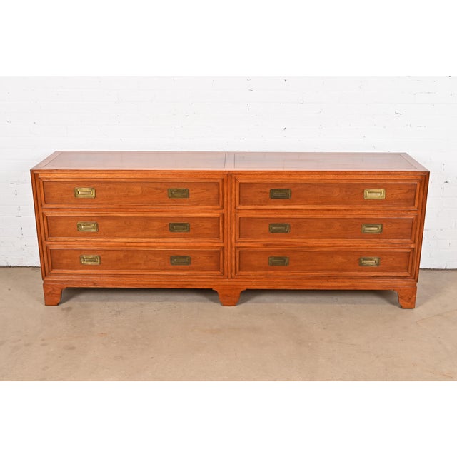 A gorgeous mid-century modern Hollywood Regency Campaign style long dresser or credenza By Baker Furniture, "Milling Road"...