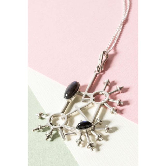 Striking silver pendant with spectrolite stones by Claës Giertta. Brutalist, imaginative design reminiscent of a...