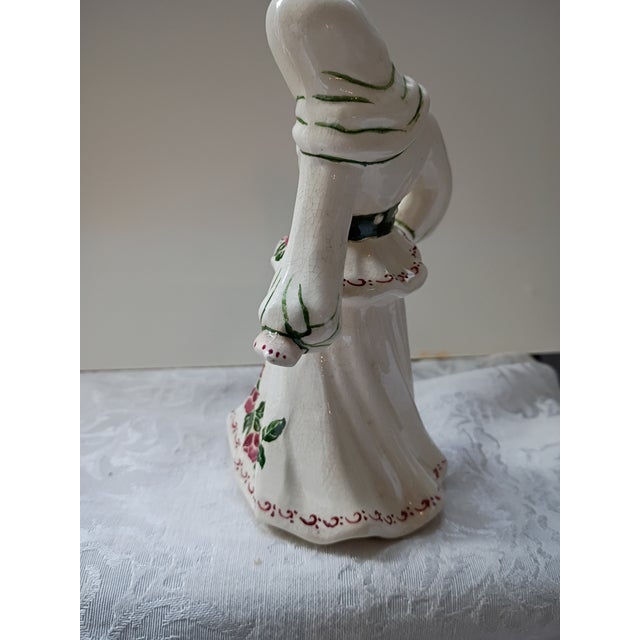 "A charming vintage mid-century ceramic figurine crafted by the renowned Ceramic Arts Studio. This piece depicts a dancing...