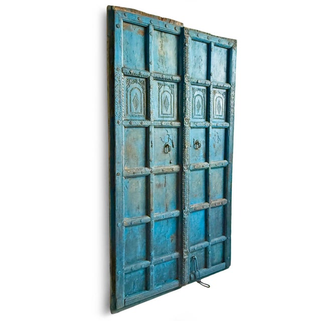 Antique blue doors from India. Intricate carved details and original brass hardware. Authentic antique with signs of age...