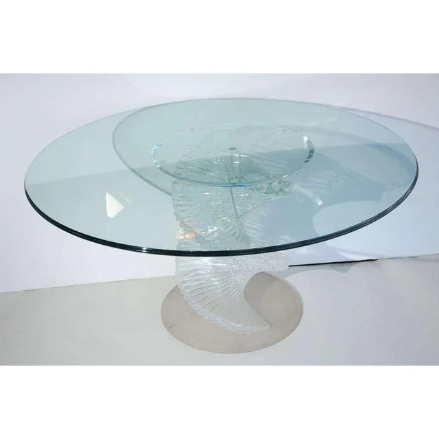 A sculptural spiraling Lucite table with a glass top. Base is frosted Lucite. Lucite spiral is clear.