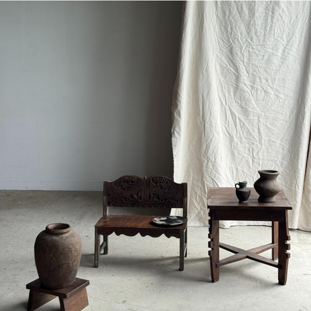 Small bench with a carved backrest featuring a stylized bird motif. A small piece of children's furniture, second-hand...