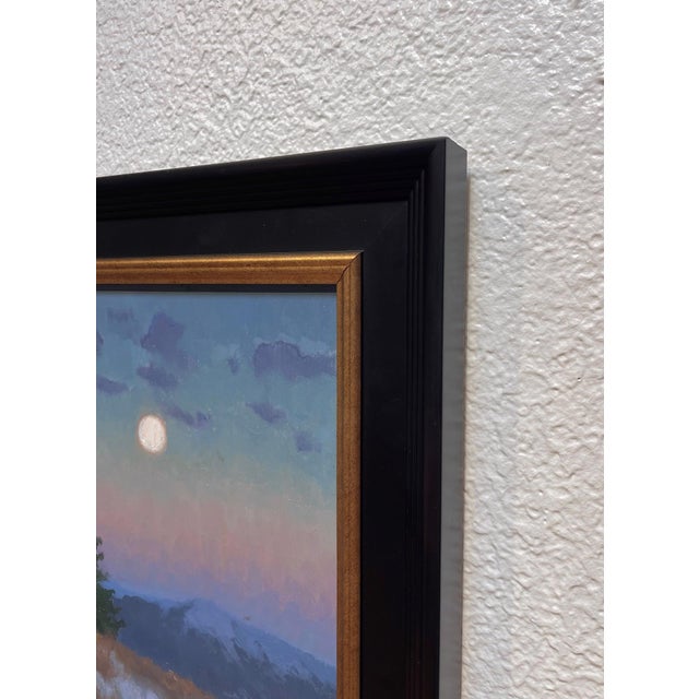 In "Winter Moon," a serene landscape unfolds under a twilight sky, where a luminous full moon casts a gentle glow over...