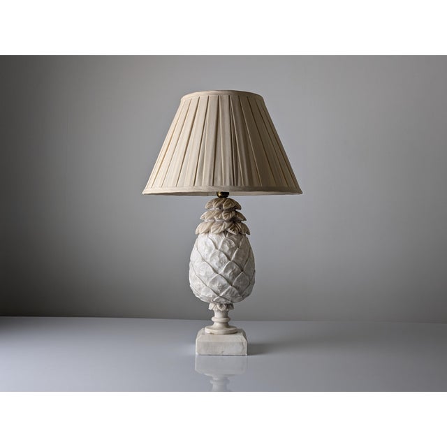 An elegant vintage table lamp, hand-carved from natural alabaster in the stylized silhouette of a pineapple, the timeless...