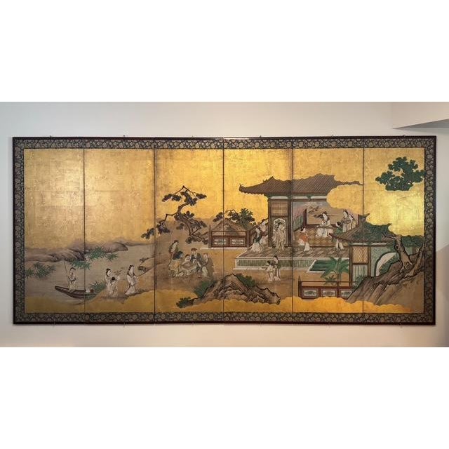 A fine and detailed pair of folding six-panel Japanese screens depicting ‘The Four Accomplishments’ (kinkishoga) through...