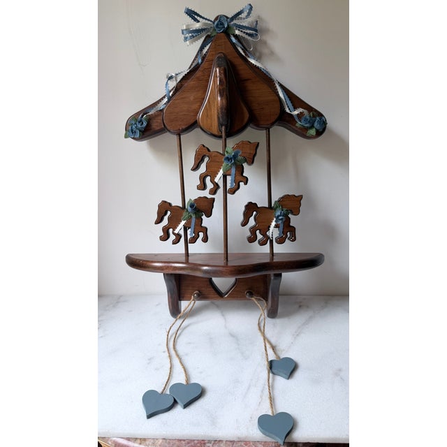 American Wooden Wall Shelf a Vintage Carousel, Featuring a Canopy Top, Three Cut-Out Carousel Horses Blue Floral Ribbons, and Dangling Heart Accents. For Sale - Image 3 of 4