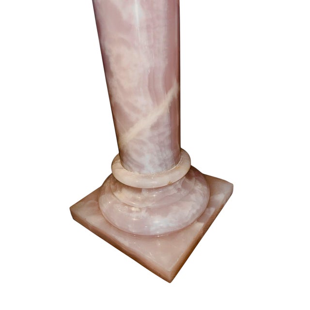 This 41‑inch solid pink marble pedestal features a smooth, polished surface with natural veining that highlights the...