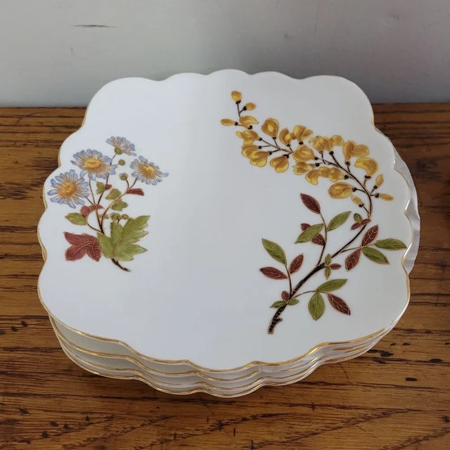 A charming set of four Austrian porcelain luncheon or dessert plates, each measuring 7.5 inches square with softly...