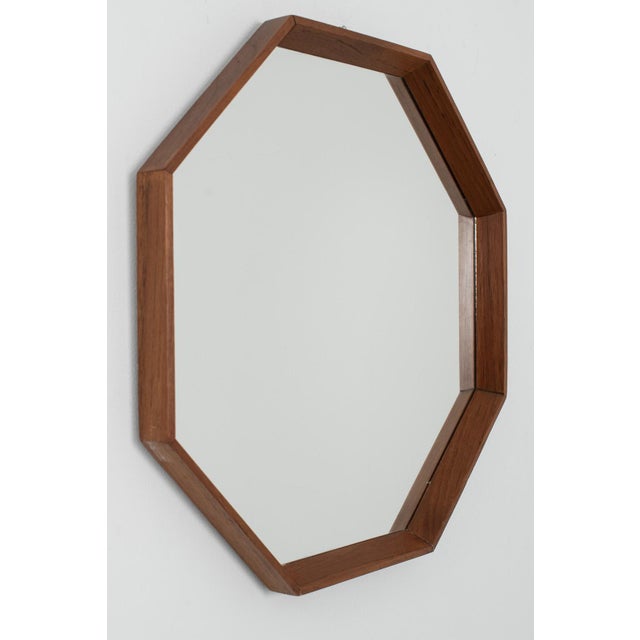 Octagonal shaped mirror from denmark. A rare model mirror in a stunning wooden frame made in the 1970's. Measurements h....