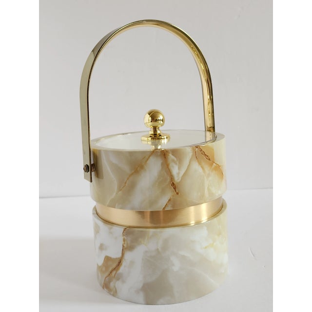 Very stylish Hollywood Regency style Morgan & Co Bucket Brigade ice bucket in a faux marble design with gold trims and...