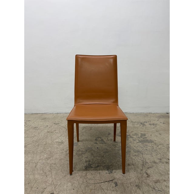 Single saddle leather dining chair designed by G. &amp; R. Fauciglietti for Frag, Italy. The color most closely matches...