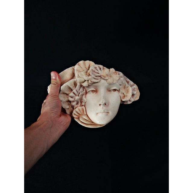 Pink plaster wall mask with Art Nouveau woman's face and flower decoration What if you hung Art Nouveau on your walls?...