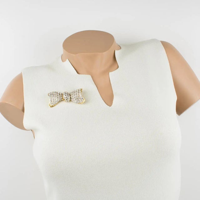 This exquisite Valentino Garavani couture brooch features a dimensional gilt metal bow-tie-shaped frame, all paved with...