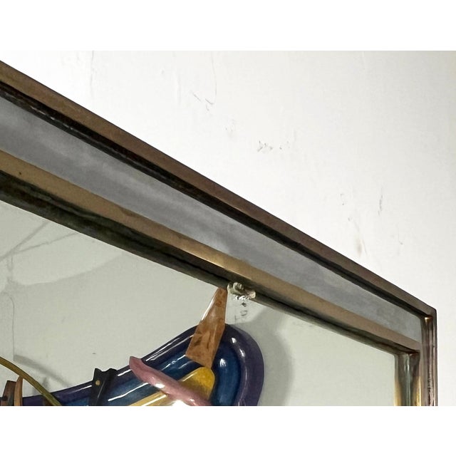 An elegant postwar (1950s) minimalist French wall mirror attributed to Guy Lefevre for Maison Jansen, in mixed metals of...