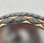 Handcrafted Moroccan round mirror featuring a metal frame inlaid with resin. The piece shows beautiful organic variations...