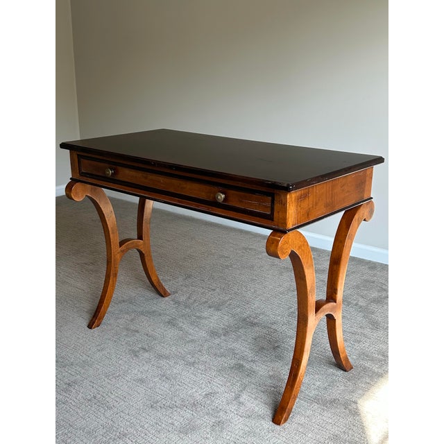 Elegant Baker Milling Road writing desk featuring a refined neoclassical silhouette with dramatic C-scroll legs and rich...