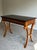 Elegant Baker Milling Road writing desk featuring a refined neoclassical silhouette with dramatic C-scroll legs and rich...