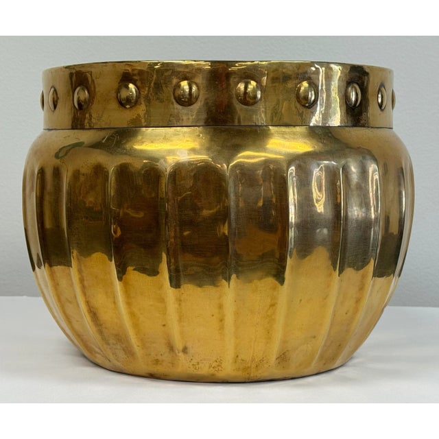 Oversized vintage brass planter pot featuring ribbed exterior with embossed rim. Great size and unique design suitable for...