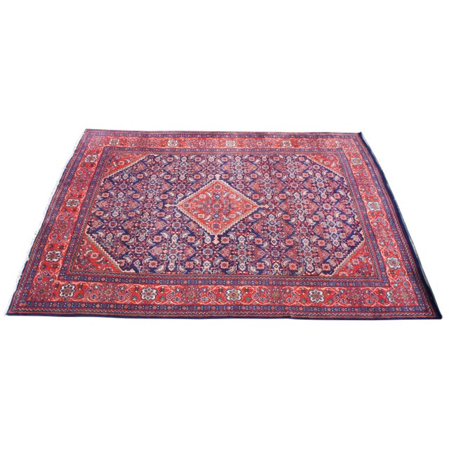 This hand-knotted wool vintage Persian / Iranian Mahal rug featuring a stepped lozenge amulet medallion surrounded by an...