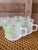 Charming set of eight vintage frosted glass mugs by Sasaki featuring a fresh lime green bamboo motif. These mid-century...