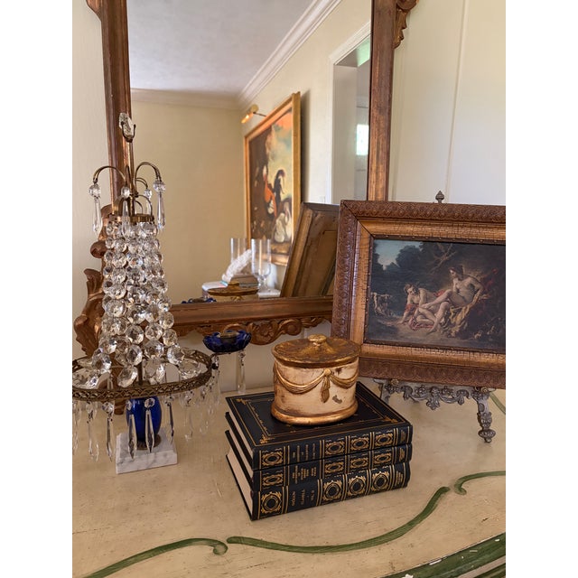 An elegant Hollywood Regency giltwood lidded box featuring carved trompe l'oeil faux swags, in a beautifully aged gold...