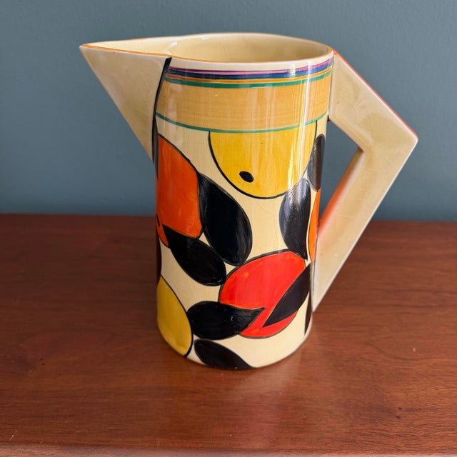 A vibrant and highly collectible Clarice Cliff Odilon shape jug decorated in the iconic Orange & Lemon pattern, dating to...