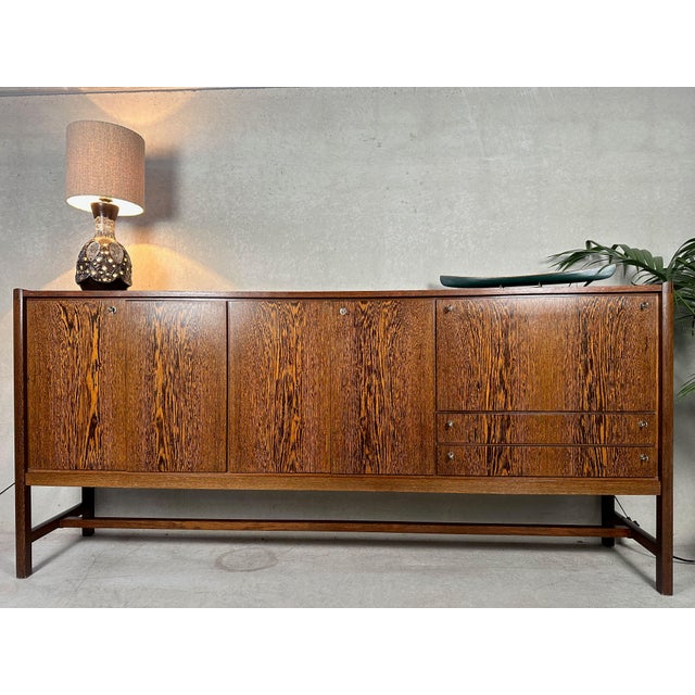 Beautiful 1960s wenge veneer sideboard/highboard with integrated desk and lighting. 4 doors (2 double) and 2 drawers....
