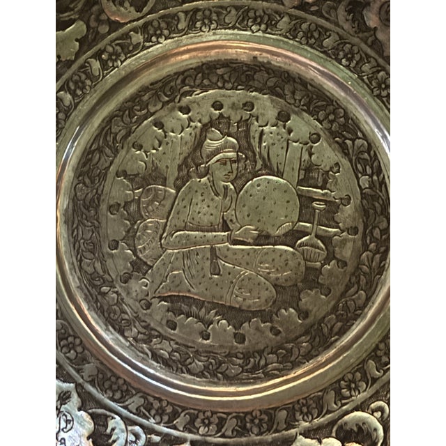 This is a beauty! The plate has a scalloped border with an intricate floral motif and depicts a scene from Persian...
