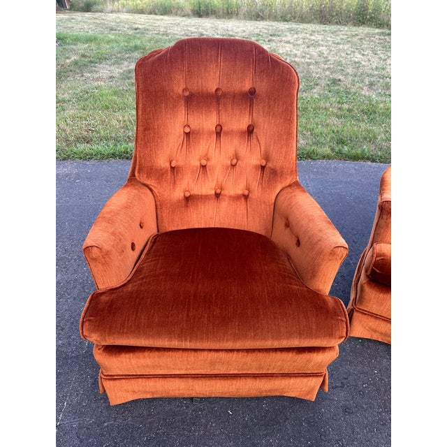 These are an identical pair of Mid-Century / 1970s Hollywood Regency swivel rocker lounge chairs. They feature a luxury...