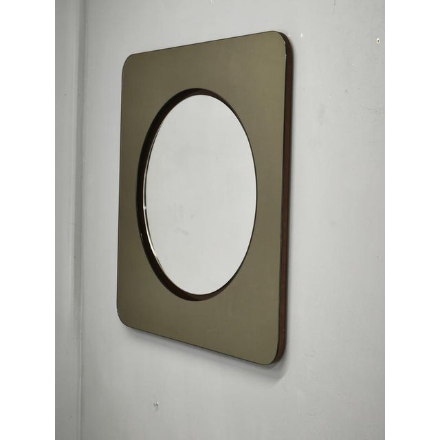 Distinctive Italian Space Age wall mirror dating from the 1970s. The mirror features a strong geometric design composed of...