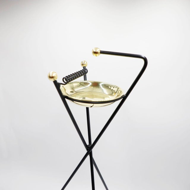 We offer this rare Atomic age ashtray on foot made of steel and brass accents, circa 1960.