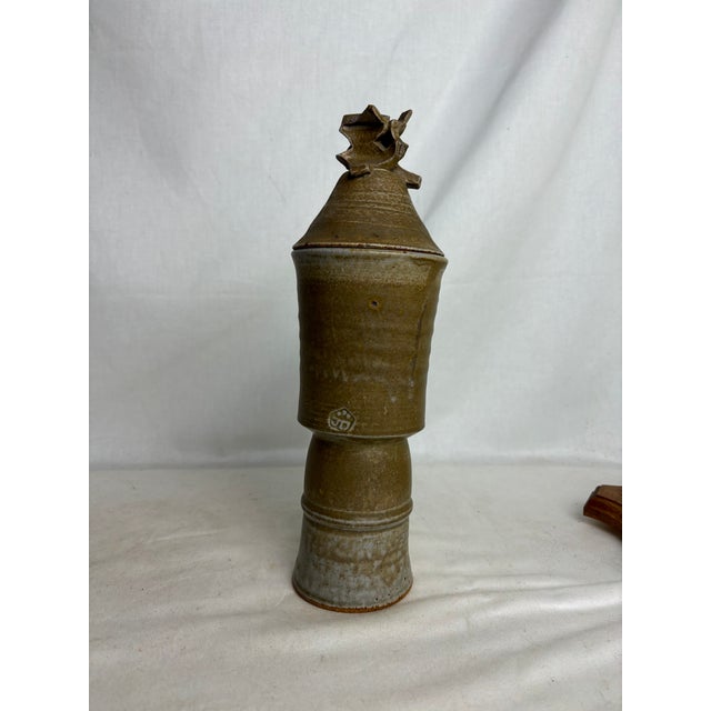 This beautiful contemporary vase will bring an earthy, grounded energy to any space. The ceramic is a rich earth tone, and...