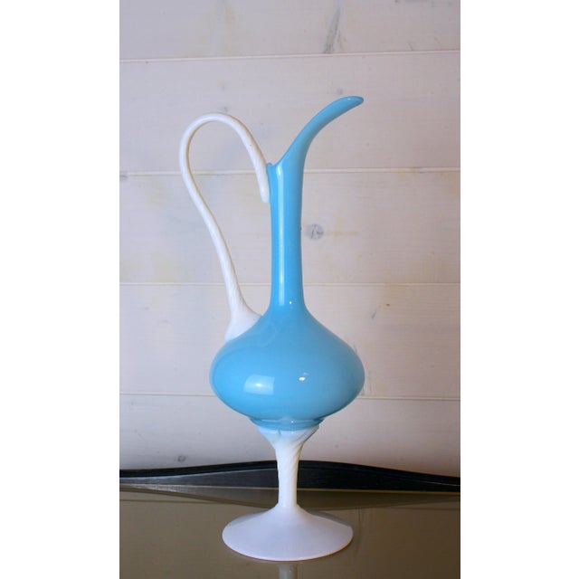 A very pretty Italian glass vase, like a pitcher or bud vase. Its shape is soft and elegant. It comes from the Florence...