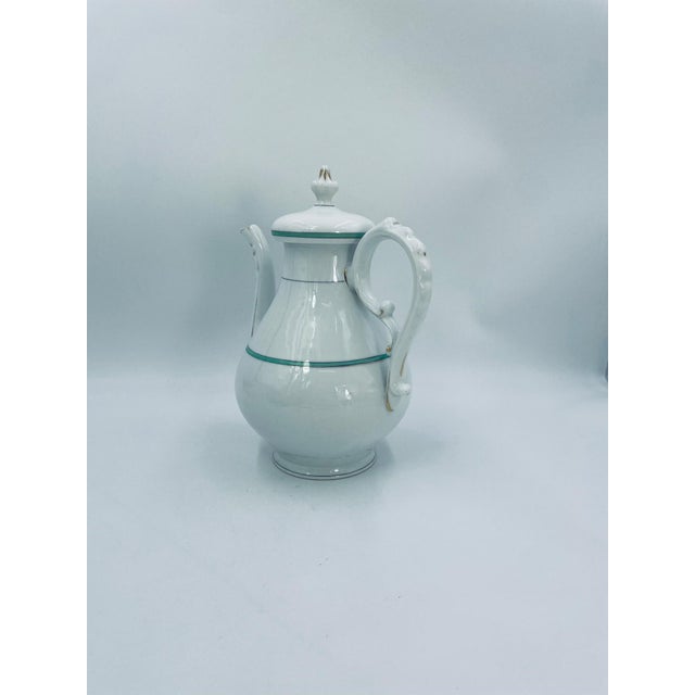 Antique teapot, manufactured in Germany in the 1920s/30s, made of high-quality white porcelain. The teapot features a...