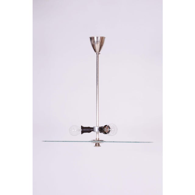 This chandelier is a monumental representative of functionalist purity and the Bauhaus movement in 1930s Czechoslovakia....