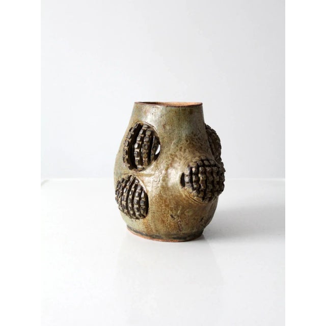 Signed studio pottery vase, hand-crafted in a free-form silhouette with an abstract sculptural design. The surface is...