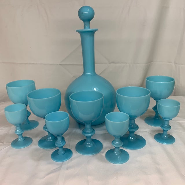 Offered here is a vintage Portieux Vallerysthal French blue opaline glass decanter and matching stemware set. Features a...