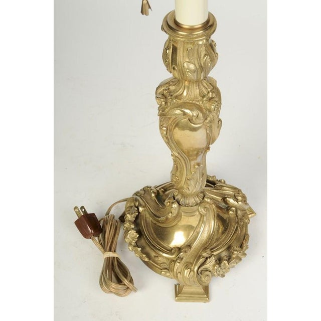 French, 19th century, serpentine form, Louis XV style taper holders with scrolling floral decorations ending on tri-...