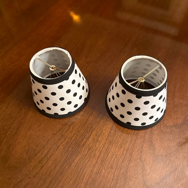 A pair of white and black polkadot candelabra bulb clip on shades. Perfect for a candlestick lamp or wall sconces.
